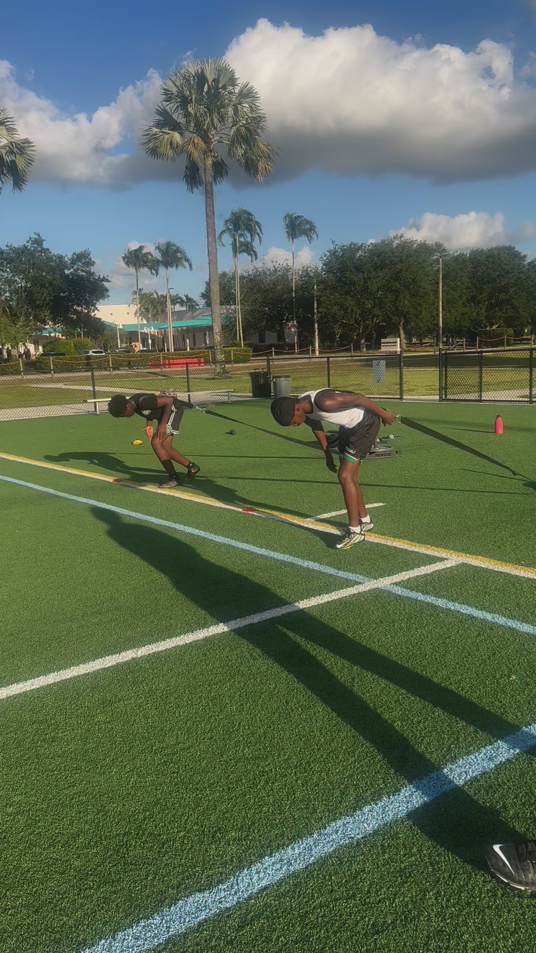 Athlete performing resisted sprint training to build power and improve sprint start explosiveness