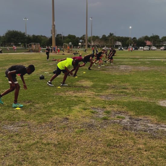 Athlete demonstrating explosive sprint start technique from standing position in Speed Kills program